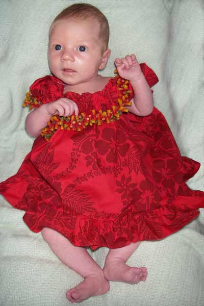 Leilani, 4 weeks old, wearing her Hula outfit