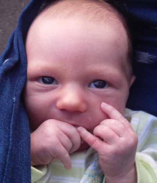Leilani, 4 weeks old, getting the Shaka wrong