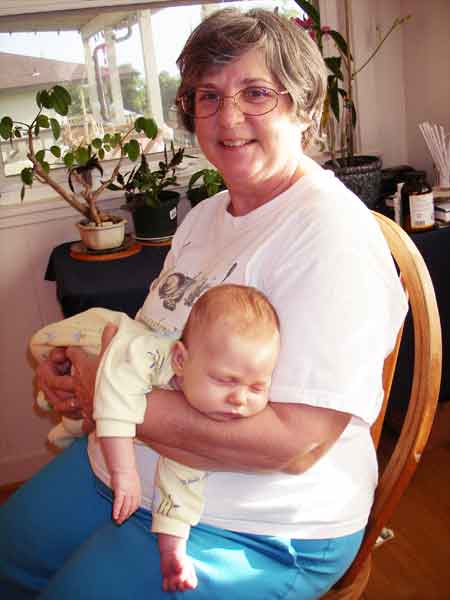 Leilani 5 weeks sleeping in Grandma Rosemary's arms