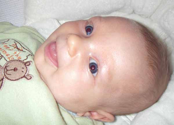 Leilani, 6 weeks old, smiling at her Bee mobile