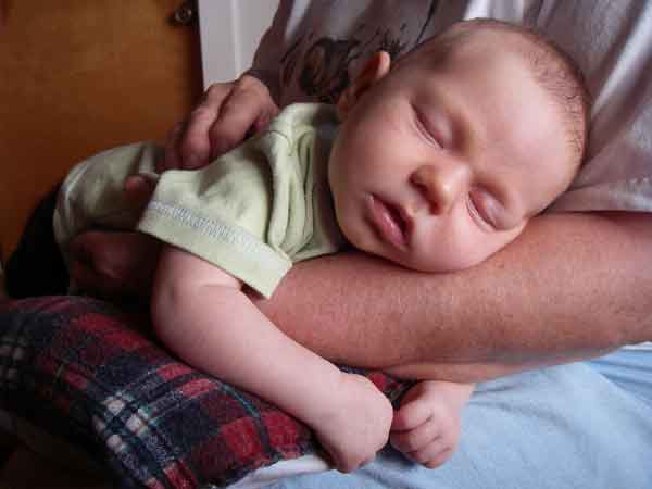 Leilani 6 weeks sleeping in Grandma Rosemary's arms